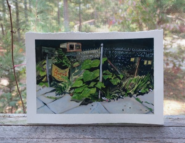 A framed painting of an urban garden placed in front of a screened window looking out on a pine forest